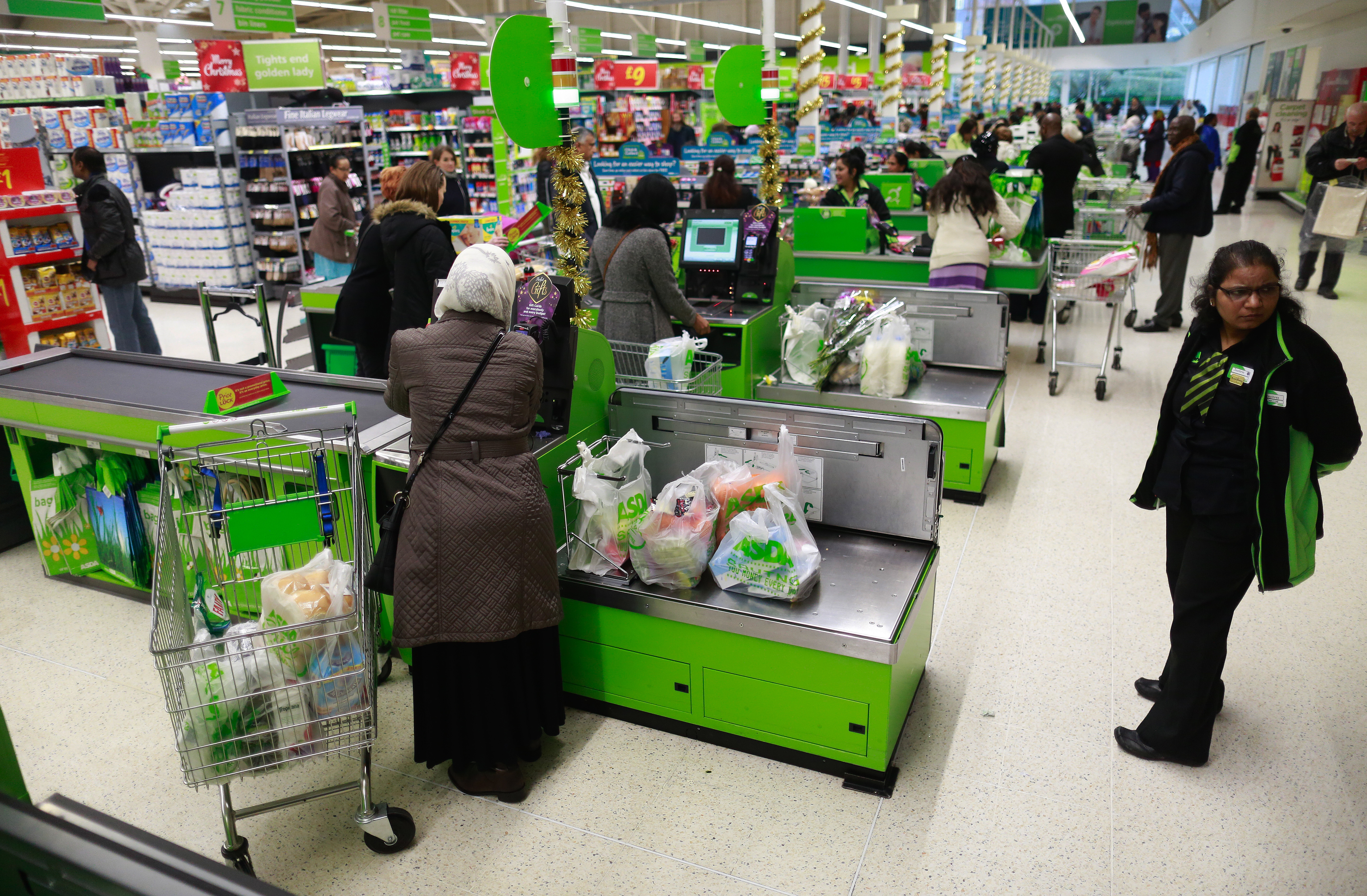 Customers at Asda supermarket checkout counters.